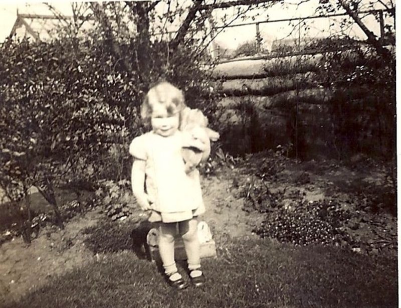 Christine pictured in the family’s back garden with the air raid shelter in the background 