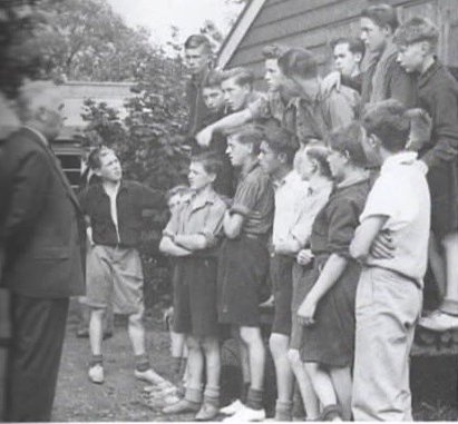 Bigwood Camp, Radley, in 1941: David is standing alone on the left as Sir Ralph Glynn, MP for Abingdon, addresses the boys. The photo is taken from David’s autobiography, Hostilities Only.